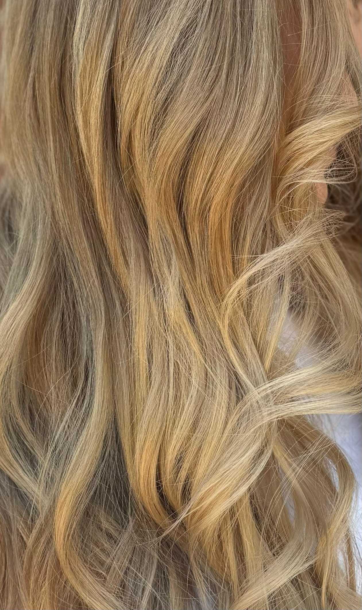 a zoomed in photo of blonde hair with bright blonde highlighting
